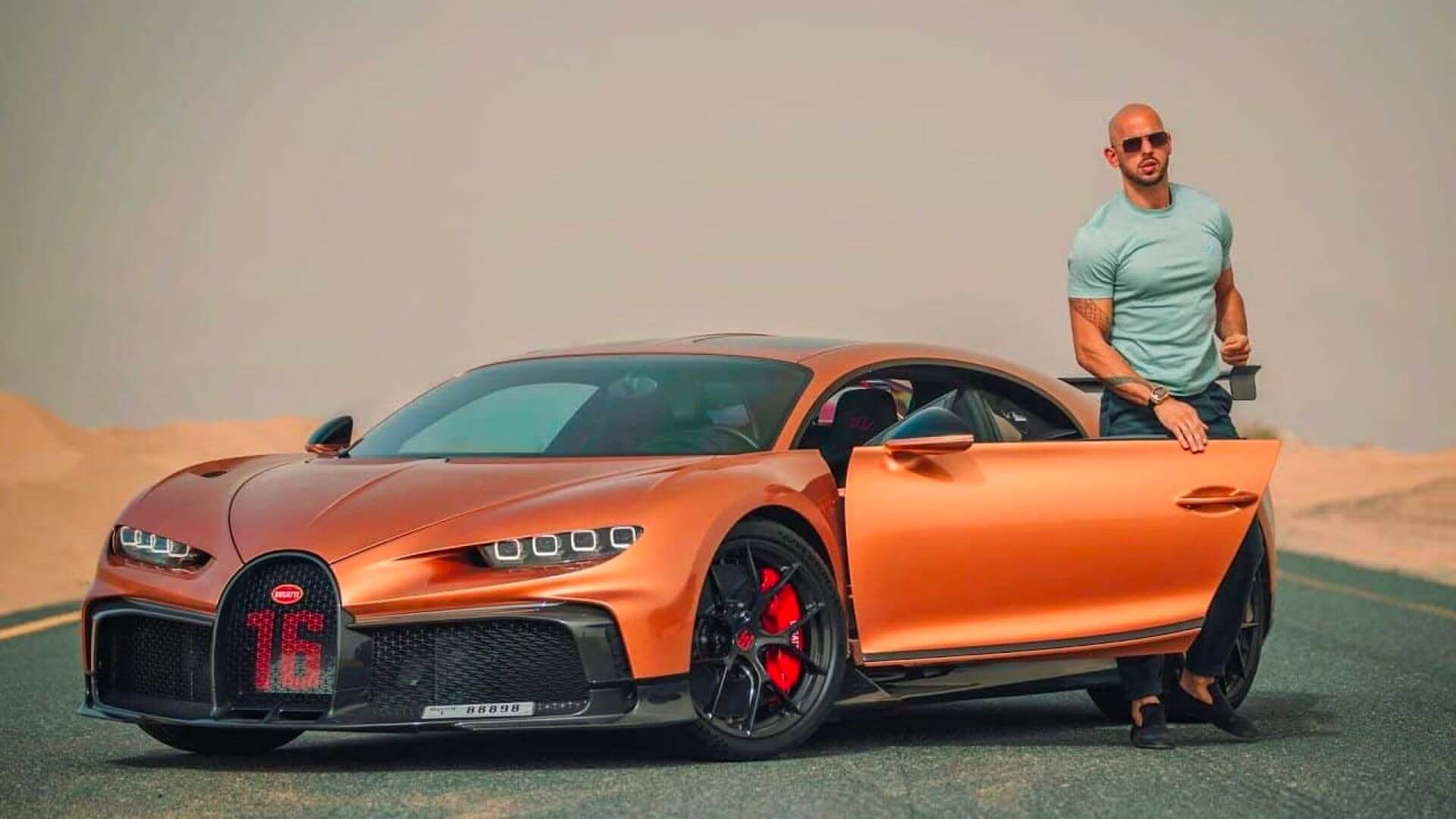 andrew tate founder of Hustlers University standing next to his sport car